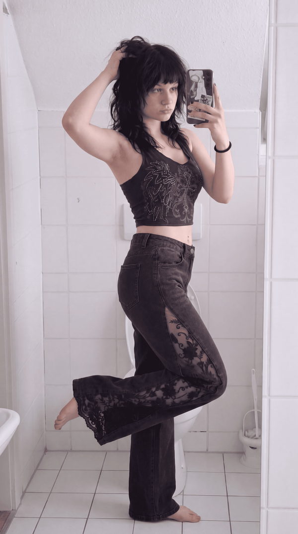 Black lace jeans styled with a crop top, mirror selfie